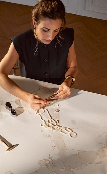 Woman tending to a plant on a countertop